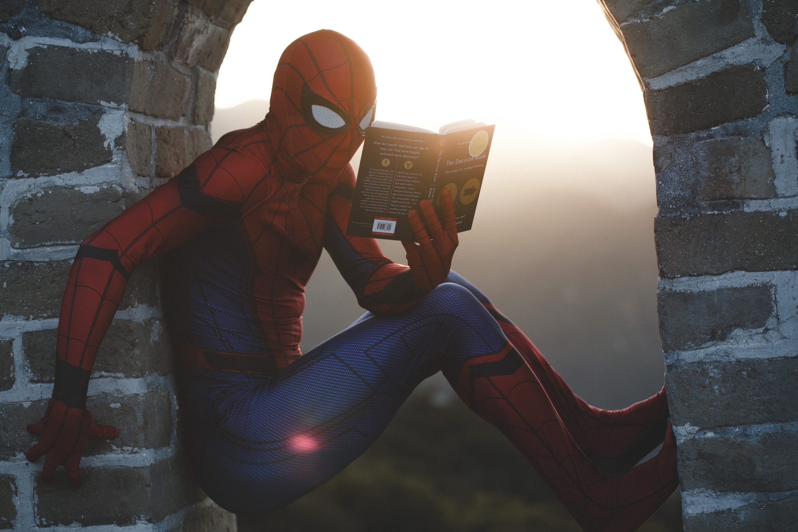 spiderman reading a book while balancing